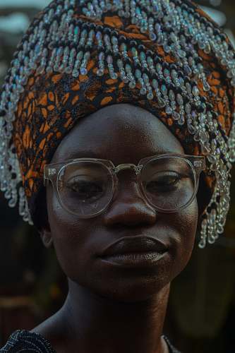 person woman wearing orange and black head dress human