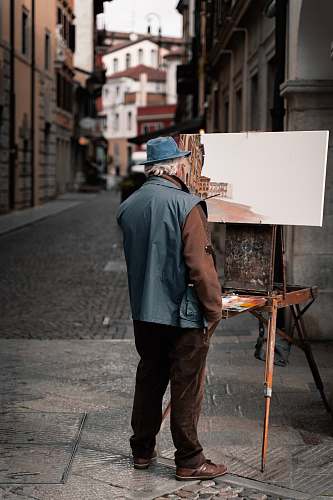 canvas man standing near easel apparel