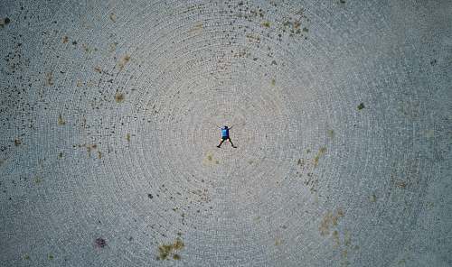 human person lying forward on gray field person
