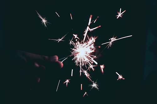  person holding sparkling light 
