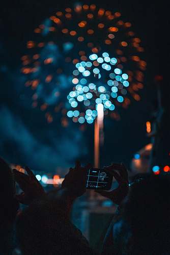  person taking picture of fireworks 