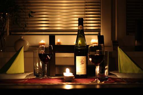 bottle wine glass filled with wine beside bottle on table comfort