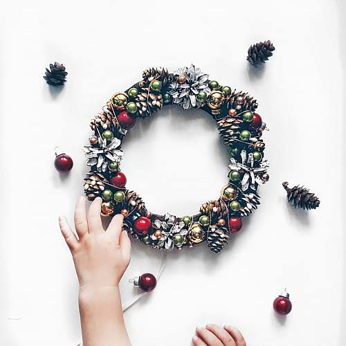 holiday person making bauble and pinecone wreath novosibirsk