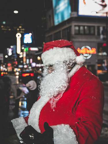festive Santa Claus standing near buildings santa