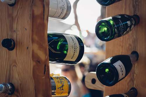 hvar shallow focus photo of bottles on brown wooden rack croatia