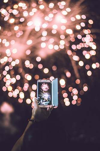 moody person taking video of pink firework display solinea resort condominium by alveo land