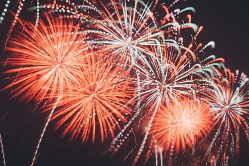 night photo of orange and white fireworks red