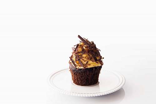 cupcake brown and white cupcake on round white ceramic plate cream