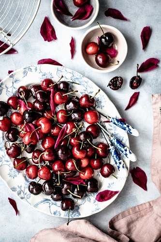 fruit red cherry fruits on oval white and blue floral ceramic plate cherry