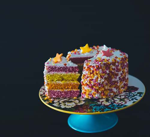 cake sliced cake top with star raisins on cake stand birthday cake