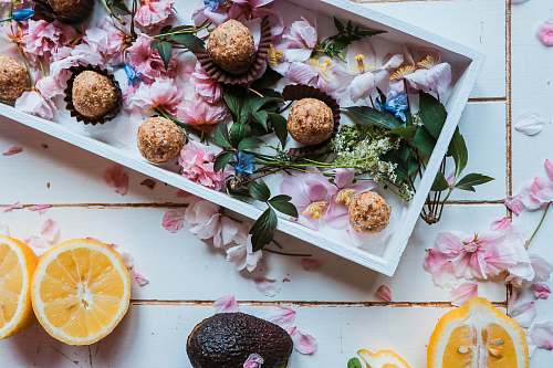 dessert sliced oranges beside plate of round pastries food styling