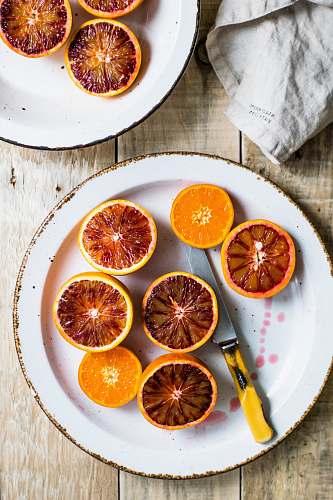bowl sliced oranges on white plate plate
