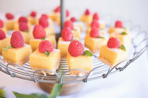 fruit square strawberry cheesecake on round gray metal stand dessert