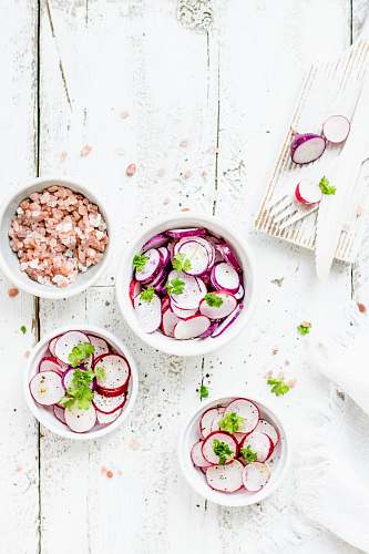 radish white ceramic bowls with foods salad