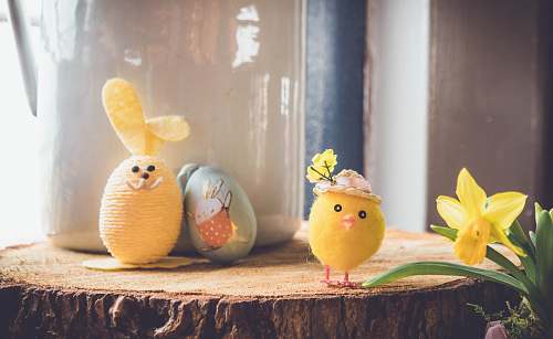 egg yellow bird plush toy on brown wood toy