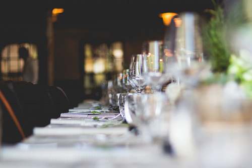 restaurant focused photo of wine glasses lined on table table