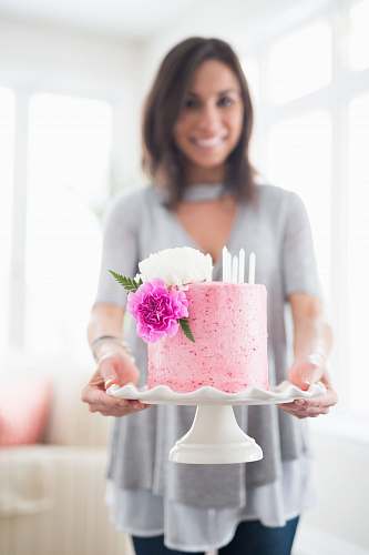 person woman holding one layer of cake with stand people