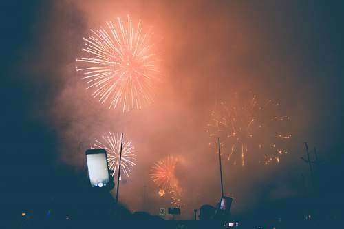 fireworks group of person taking photo and video on firecrackers outdoors