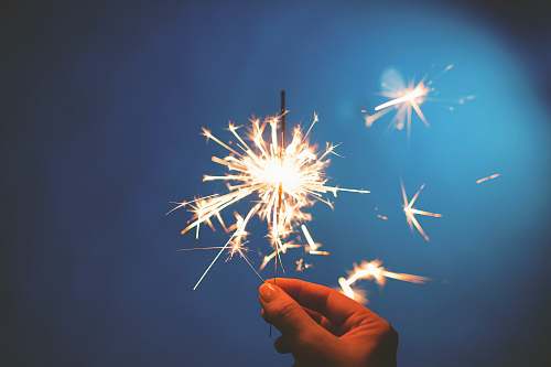 fireworks person holding sparkler outdoors