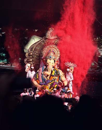 person Ganesha statue surrounded by people human