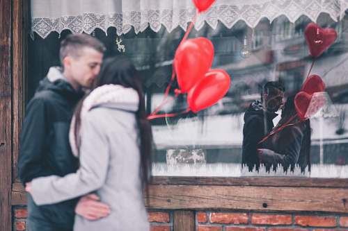 human man and woman kissing person