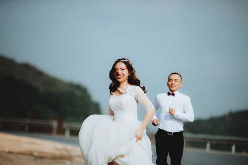 person man chasing woman during daytime human