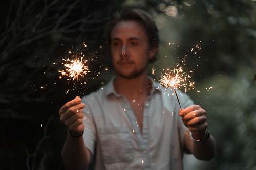 person man holding sparklers human