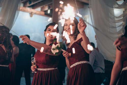 human long exposure photography of holding firecracker dance pose