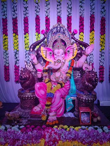 human Lord Ganesha sitting statue crowd