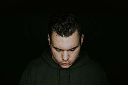 human man in green pullover hoodie looking down people