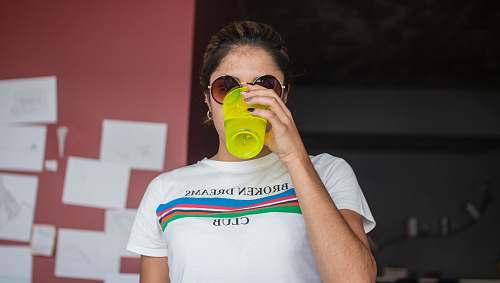 human woman wearing white crew-neck shirt cup