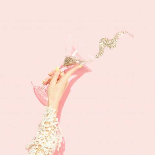 party person holding clear martini glass glitter