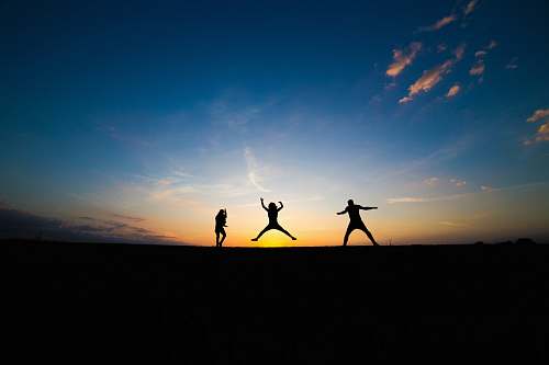 outdoors silhouette of three person jumping silhouette