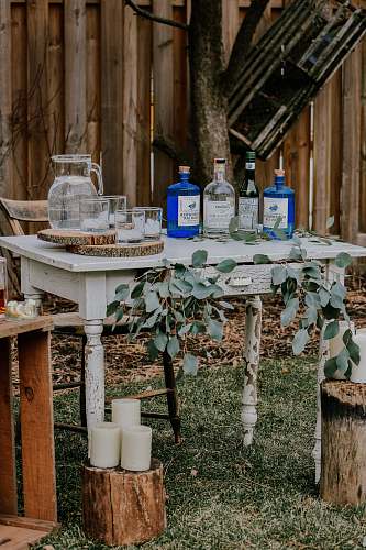 pot white wooden table with bottles on top liquor