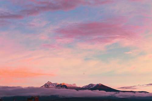 sky aerial photography of mountain under clouds during golden hour sunrise
