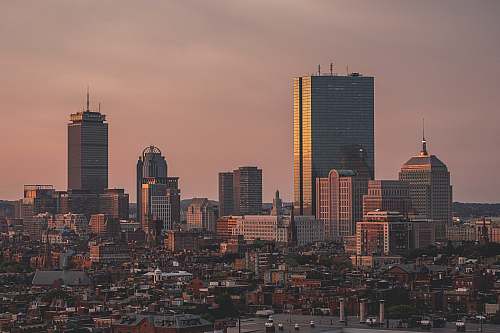 city aerial view of city under cloudy sky during daytime urban