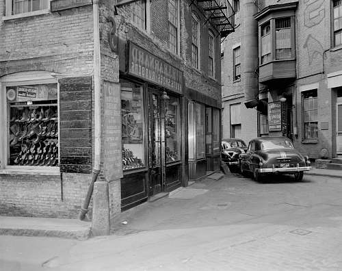 car grayscale photo of cars parked beside building street