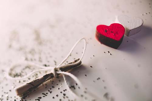  macro shot photography of red and white heart ornament 