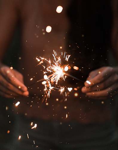 person holding fire works 