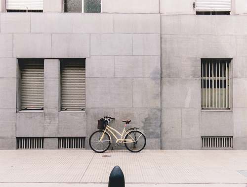 grey person taking photo of white parked bicycle buenos aires