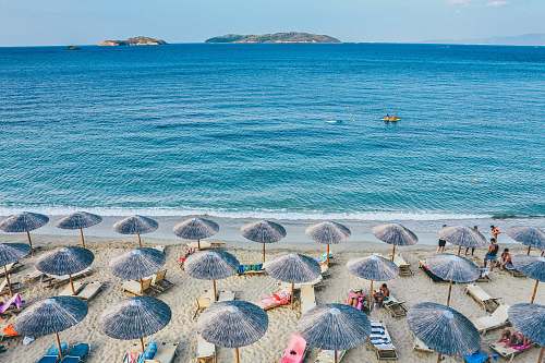 umbrella beach lounge on seashore facing the sea greece