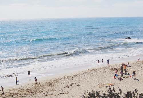 water group of people standing on seashore sea