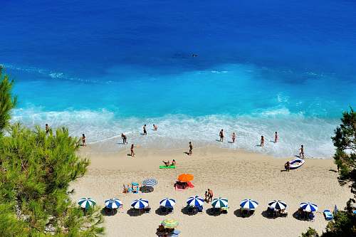 sea group of people swimming on beach greece