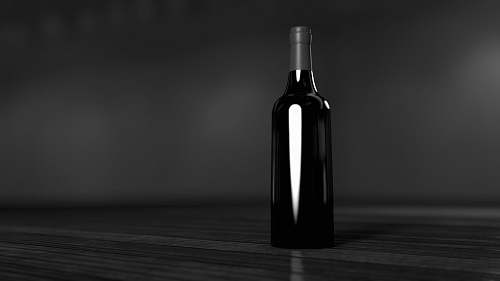 black-and-white black glass bottle on brown surface wine
