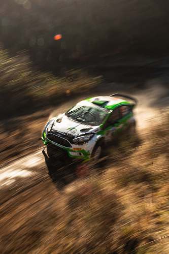 automobile white and green racing car on dirt road transportation