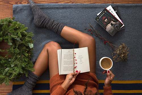 reading opened book on person's lap with gray socks book