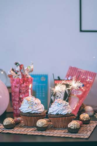 icing candles and sparkler on cupcakes cream