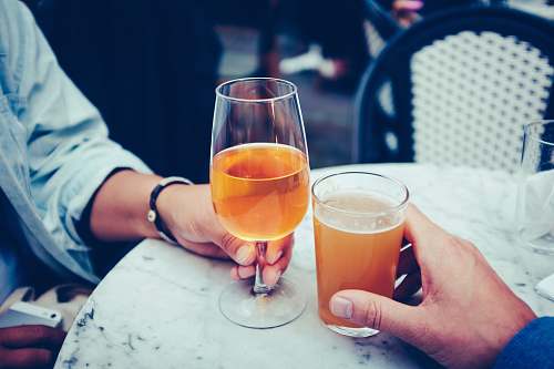 beverage person holding goblet glass and highball glass glass