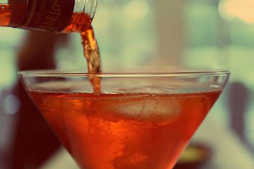 cocktail red liquid poured over clear martini glass alcohol