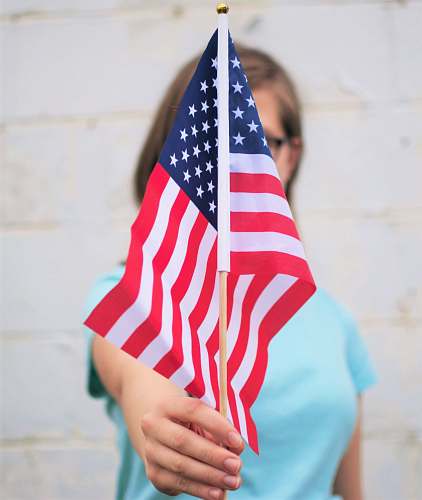 red person holding USA Flag america